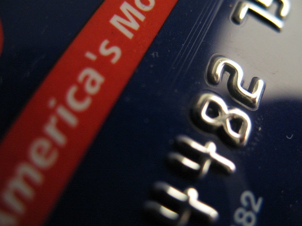 Bank card and laptop on a desk
